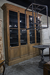 english display cabinet with solid glass doors above panel doors.