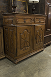 french country oak cupboard with two solid carved doors below two drawers and key locks/pulls.