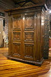 italian two door cabinet with paneled doors and dental moulding detail