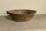 large spanish wooden bowl with handle on one side for balancing.