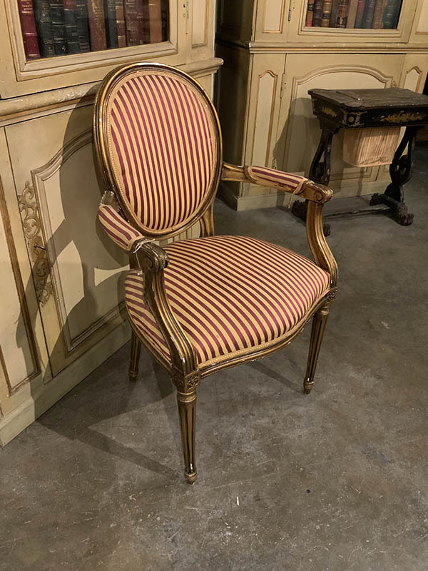 Louis XVI Gilded Open Armchair With Oval PAdded Back, Tapered And Fluted Legs