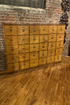 mahogany & brass fronted unit of thirty drawers
