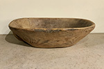 large spanish wooden bowl with handle on one side for balancing.