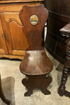 pair of english mahogany hall chairs: sgabello form, decorated with armorials